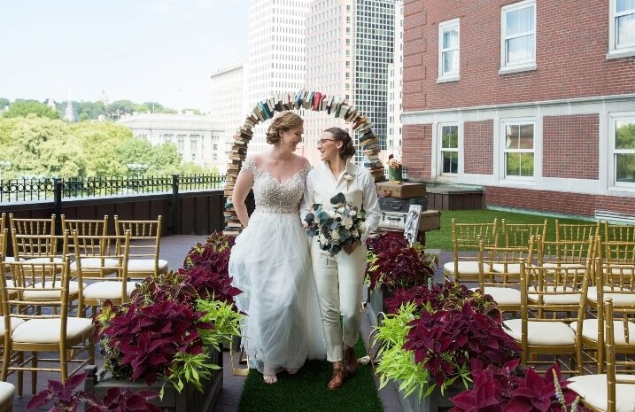 A couple walk down the aisle on a rooftop at Providence Graduate in RI