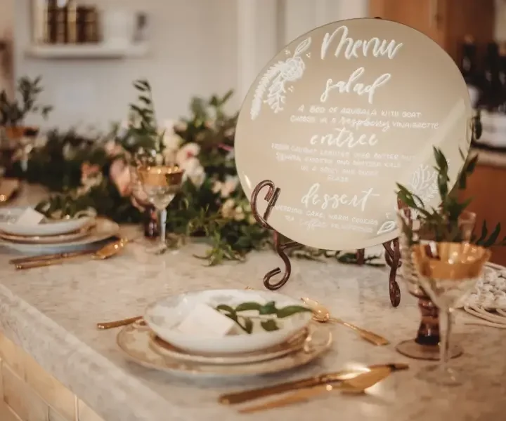 photo of table settings of gold and crystal